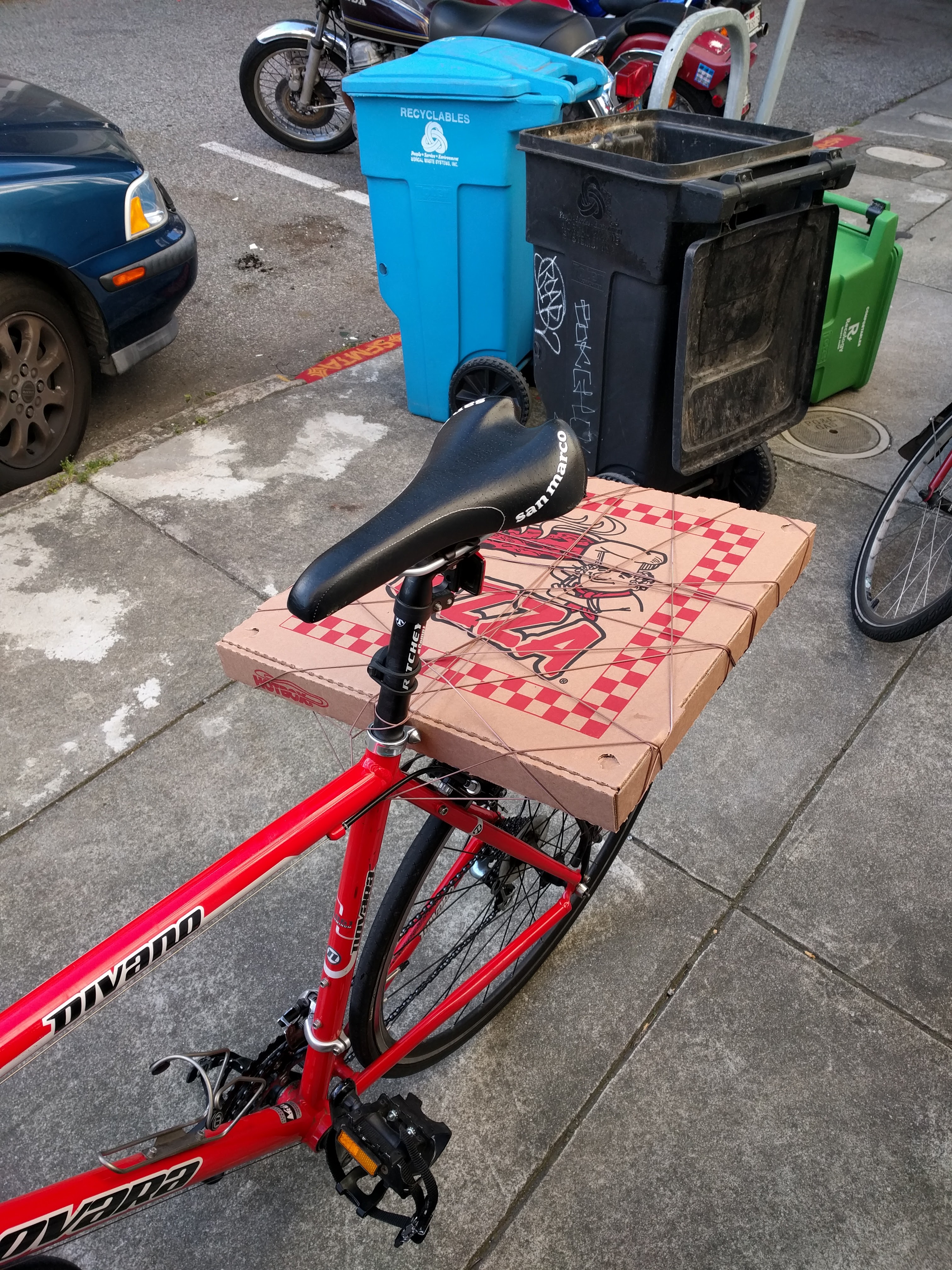 Bike with pizza tied to the back